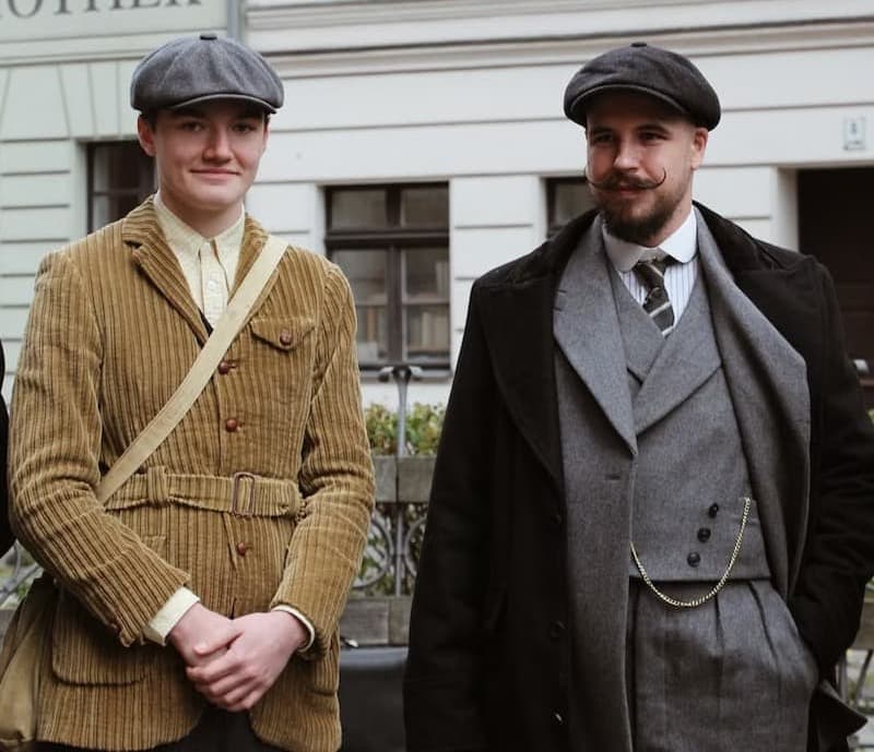 Two men in vintage clothing outdoors