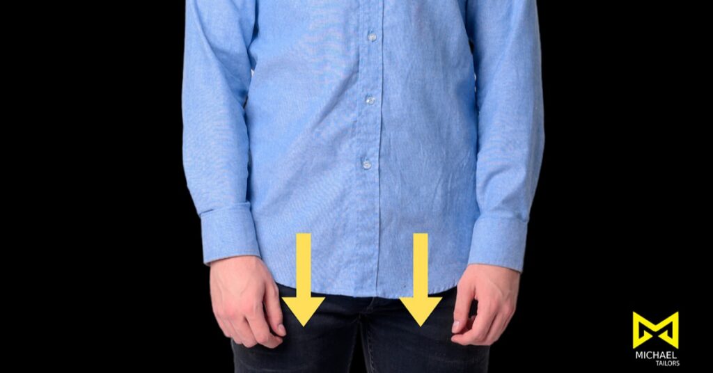 Person wearing a blue shirt with hands down