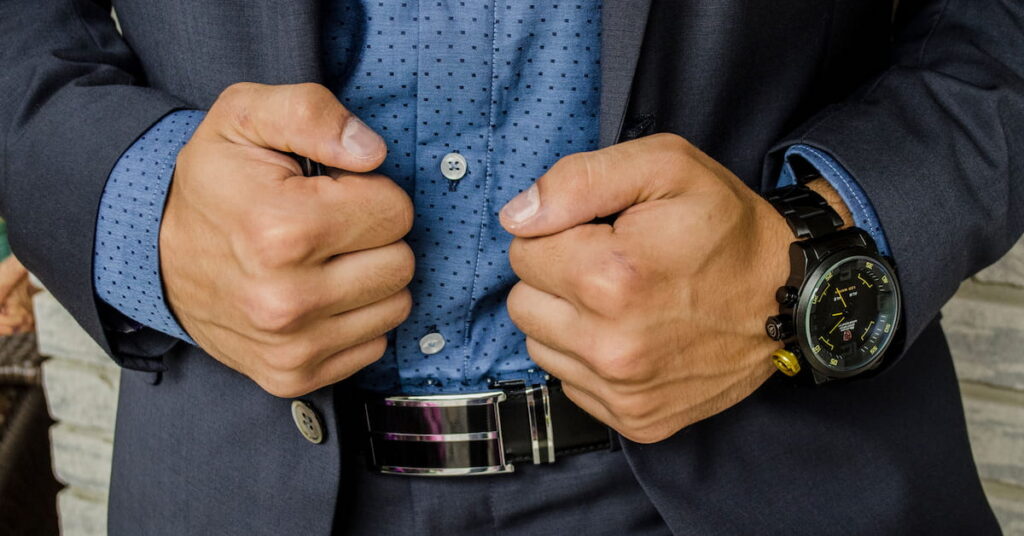 Close-up of a man’s hands in a suit