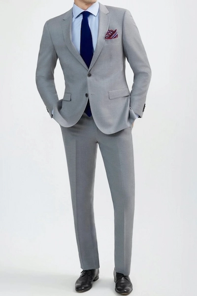 Man in a gray suit and blue tie
