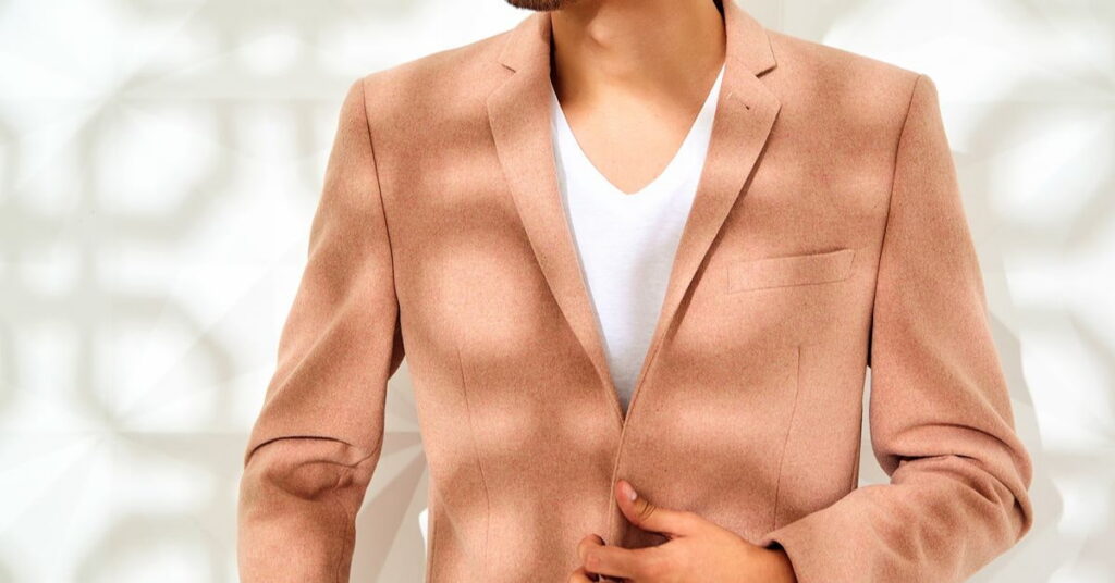 Man wearing a rust suit and white shirt