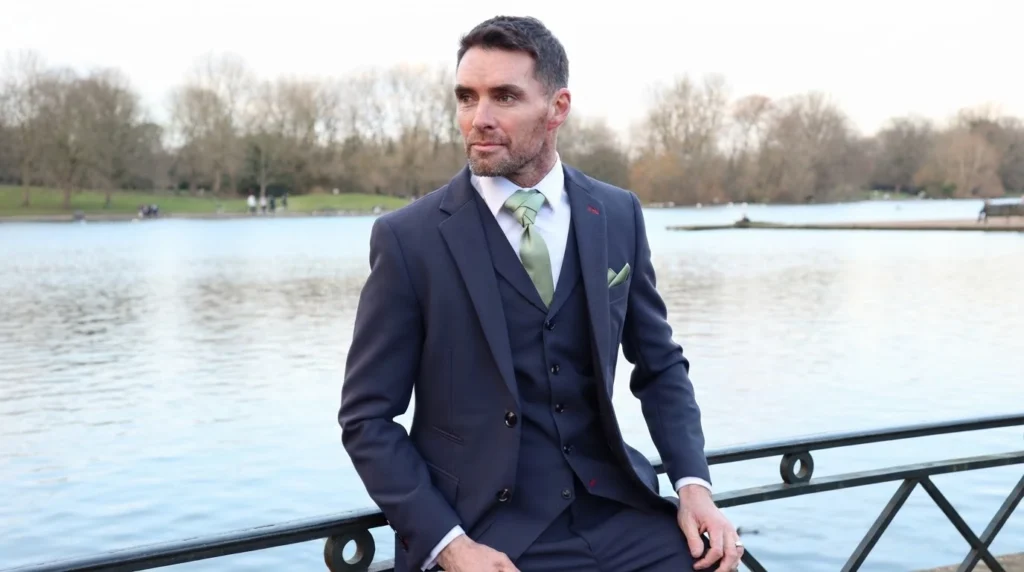 Man in suit by a lake