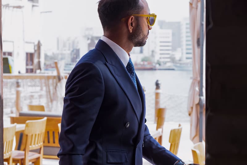 Man in a suit looking out a window