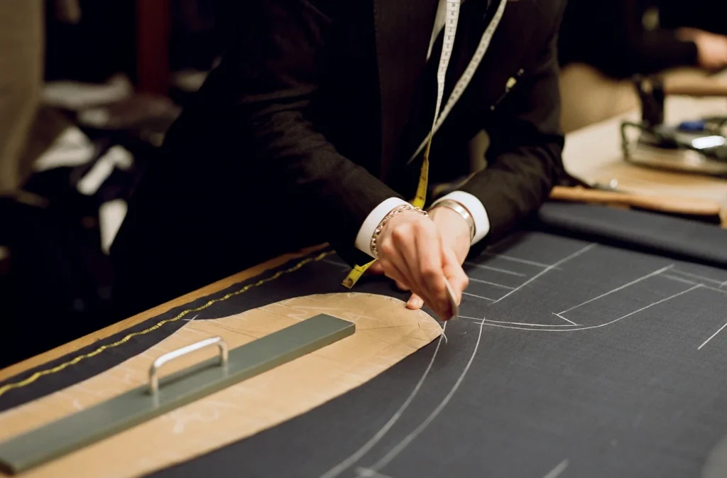 Tailor drafting patterns on fabric